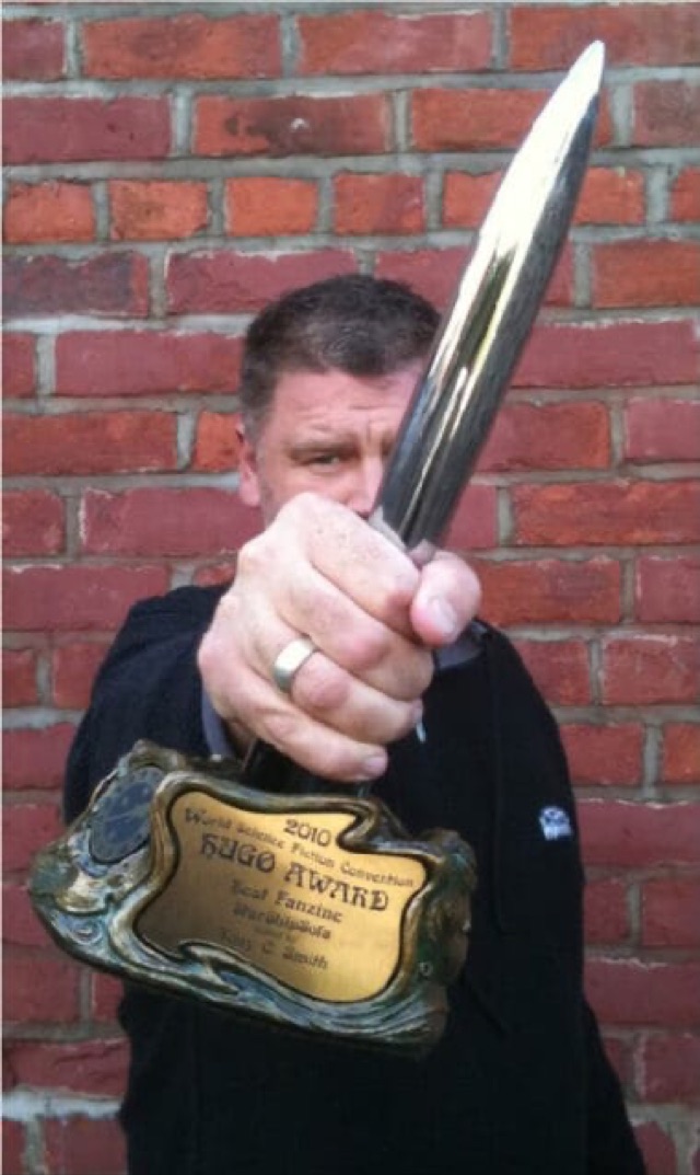 Tony C Smith pointing the 2010 Hugo Award rocket at the camera